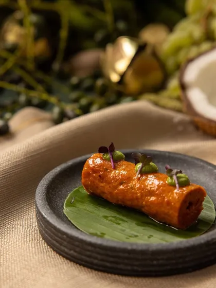 A close-up of a modern Indian kebab, elegantly plated on a banana leaf and garnished with microgreens for our Diwali menu.
