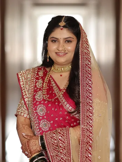 A full portrait of the bride in her reception attire. The makeup is elegant and sophisticated, perfect for a grand celebration.