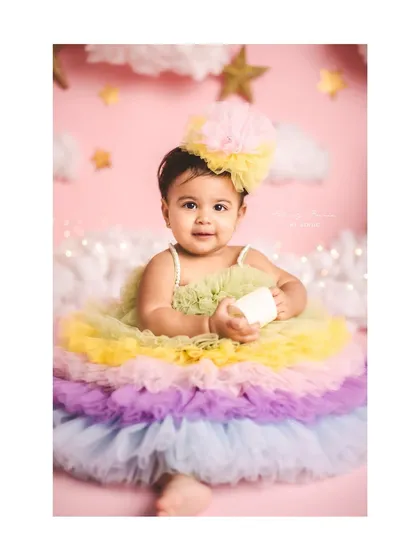 A rainbow of tulle for this little star's first birthday. The pastel colors and dreamy cloud background make this a sweet and joyful setup.