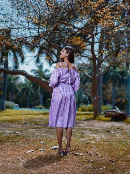 A view from the back, highlighting the design details of the dress and creating a sense of looking forward into the scenic landscape.