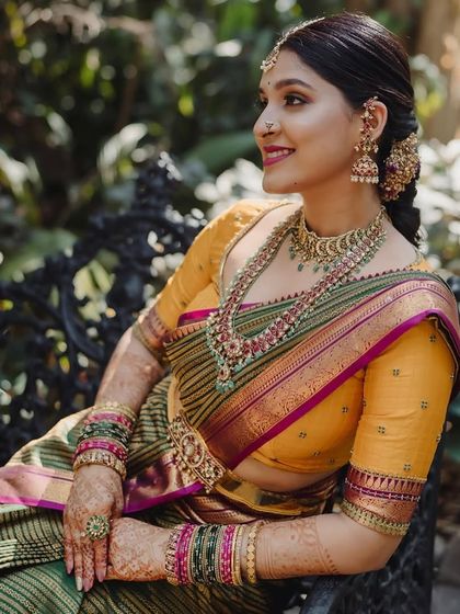 A side profile of Akanksha during her engagement, highlighting her traditional jewelry and the custom mustard yellow blouse.