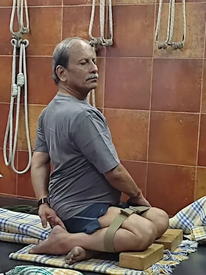 Demonstrating a seated pose using blocks and a strap. My online classes guide you on how to use common household items as effective yoga props.