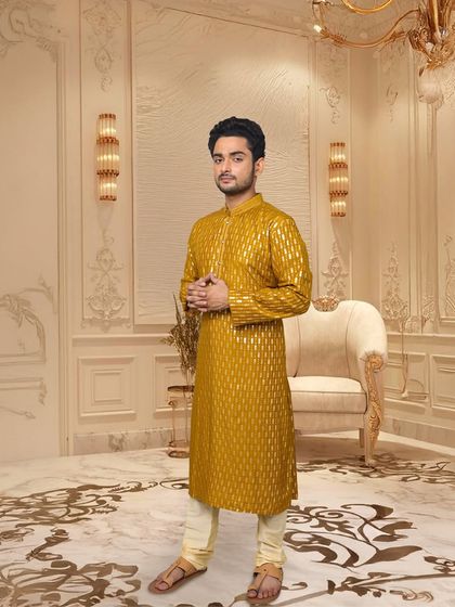 This mustard yellow kurta with a woven geometric pattern is a fantastic choice for a Haldi or Mehendi ceremony. It’s bright, festive, and has a touch of regal shine.