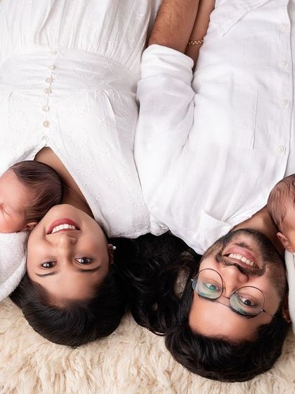 A creative overhead shot of parents with their newborn twins, creating a beautiful, symmetrical family portrait.