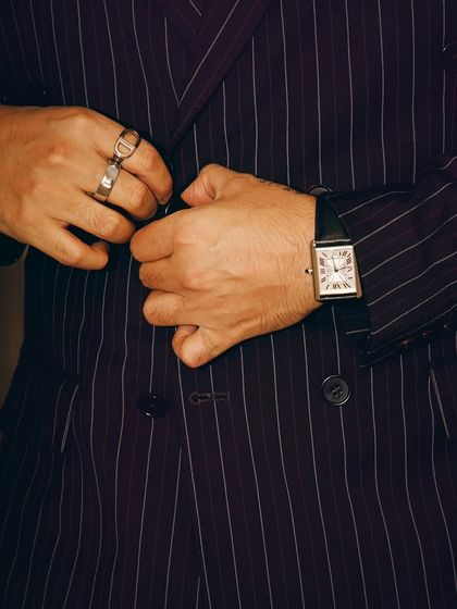 Details matter. This close-up shows the accessories we chose for Arjun Kapoor's look: a classic watch and statement rings that add a personal touch to the formal pinstripe suit.