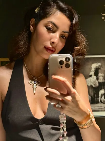 A selfie capturing the personal connection to jewellery. The diamond cross necklace is a versatile piece that can be worn daily as a personal statement of faith and style.