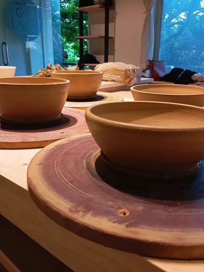A student's first time throwing heavier bowls. The pride in her progress is evident in this stack of freshly thrown ramen bowls.
