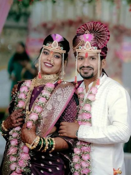 A classic, frame-worthy portrait of the smiling couple, perfect for a Maharashtrian wedding album. We make sure to get those essential shots for the family.