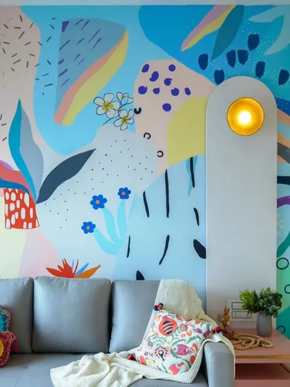 This room is designed to spark instant joy. The vibrant, abstract wall mural by a collaborating artist becomes the stunning centerpiece of this fun and energetic space.