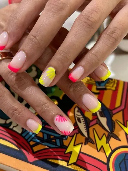 The bright neon yellow and pink tips make this French manicure a fun and eye-catching statement.