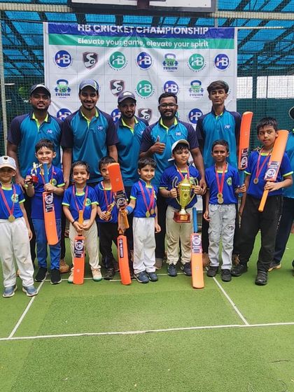 The next generation of cricket stars with their coaches and trophy at the HB Cricket Championship. We provide a complete support system for our teams.