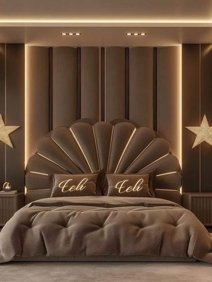 A symmetrical view of the magnificent shell-shaped headboard, flanked by matching bedside tables and star-shaped wall lights. The plush, tufted bedspread adds to the room's five-star hotel feel.