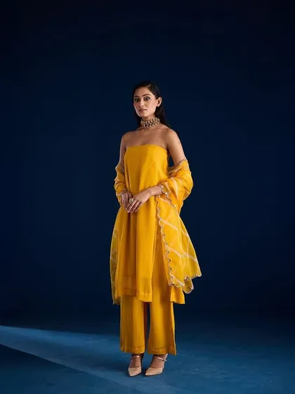 A full-length shot of the Alora Set from Aapro against our custom-painted deep blue backdrop, creating a striking color contrast.