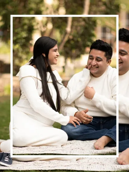 A candid and joyful moment from a park photoshoot. The genuine laughter and interaction between the couple make this a heartwarming and authentic portrait.