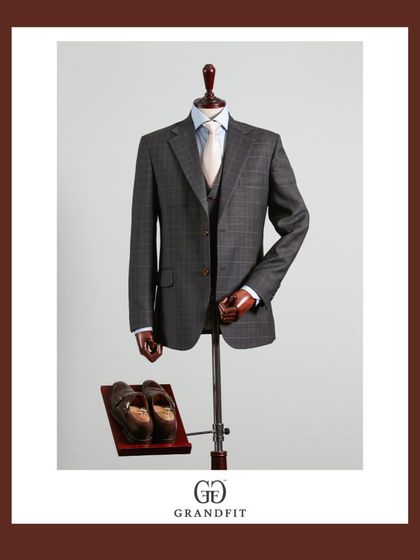 A sophisticated grey plaid three-piece suit. The pattern is subtle enough for professional settings but adds a distinct touch of character and style.