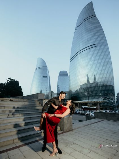 A classic romantic dip pose with a modern twist, set against the futuristic architecture of Baku. The image perfectly balances intimacy with a grand, impressive background.