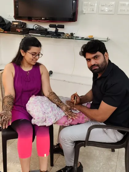 A happy client posing with me after her mehandi session. Building a good relationship with my clients is important to me.