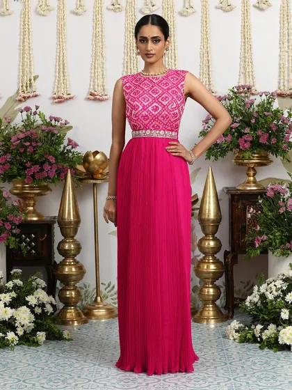 The full view of the hot pink pleated gown, a vibrant and joyful choice for any celebration.