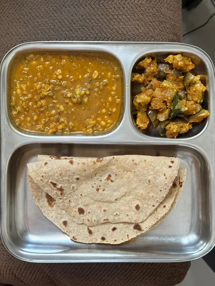 A light meal of chapati, moong dal, and sautéed brinjal. This is a great option for a quick and healthy dinner.
