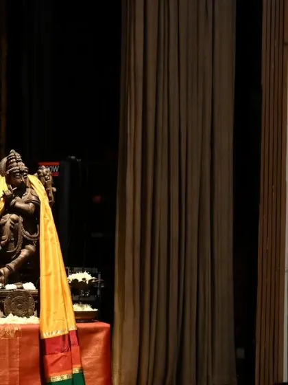 The stage setting for an arangetram is carefully considered to create a divine ambiance. The traditional lamp and the idol of Lord Nataraja bless the space before the performance begins at the Chinmaya Mission Auditorium.