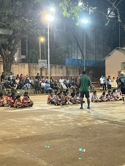 A wide shot of the court during the finals, with young players and the audience watching intently.