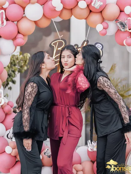 A sweet moment from the bachelorette party, with the bride-to-be getting kisses from her best friends.