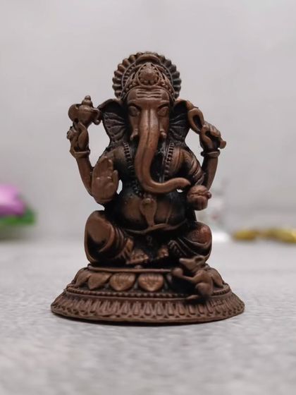 A copper-finish Ganesha idol with beautiful detailing. The antique finish gives it a very classic and revered look.