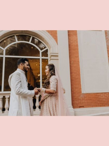 A sweet moment between the couple against a grand architectural backdrop.