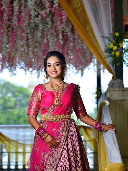 Tanu looking radiant and happy under a beautiful floral canopy at her engagement ceremony.