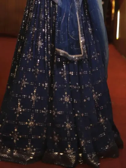 A close-up of the intricate work on the blue mehndi lehenga.