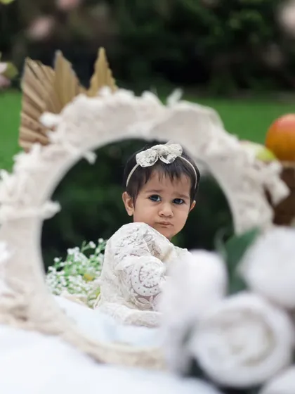 A beautiful reflection. This creative shot was taken during a boho-themed first birthday shoot outdoors. The mirror adds a unique and artistic touch.