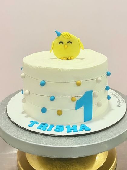 Simple, cute, and perfect for a first birthday. This cake features a little chick topper, the number one, and colorful polka dots for a clean and cheerful design.