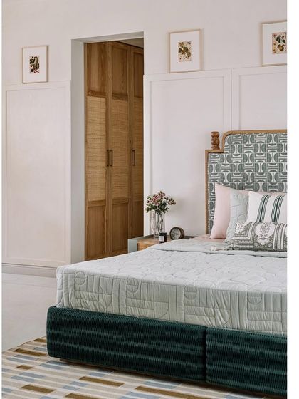 The guest bedroom is inspired by cottage living, creating a calm and welcoming space. The design features a mix of patterns and textures, with a view out to the main deck.