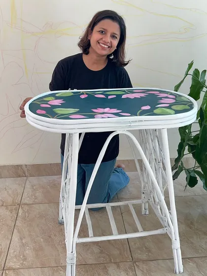 The finished cane table, now with a durable and artistic wooden top. This hand-painted furniture piece is now ready for many more years of use.