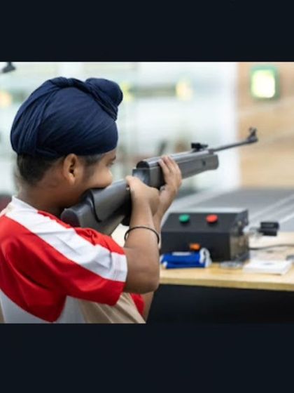 Even our youngest members learn the fundamentals of safe and effective shooting. Here, a young boy takes aim with an air rifle under careful supervision.