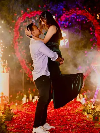 That magical "yes" moment deserves a fairytale setting. I designed this romantic proposal spot with a heart-shaped floral arch, hundreds of candles, and a custom "Will you Marry Me?" neon sign.