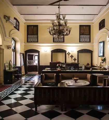 We transformed this 19th-century haveli in Old Delhi into a contemporary home, proving that heritage spaces can be adapted for modern luxury. The restored black and white marble flooring, grand chandelier, and carefully curated furniture create a living space that is both historic and elegant.