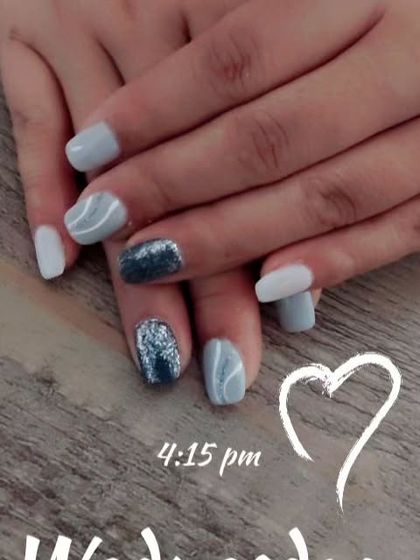This manicure combines solid light grey nails with a marble-effect accent nail and a full-coverage silver glitter nail. It's a great example of how to mix textures and finishes in one set.