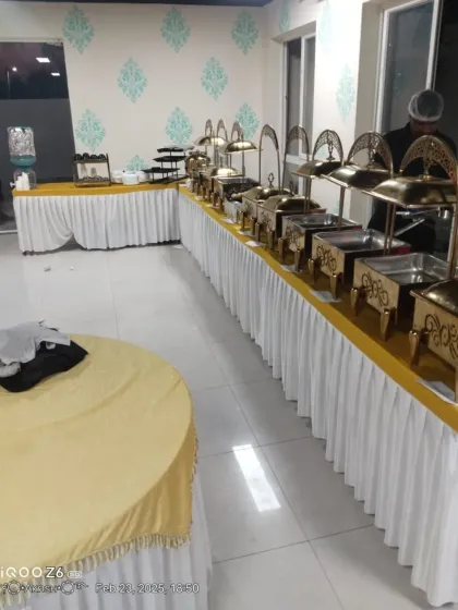 A clean and professional buffet arrangement in a modern event space. We ensure our setup is neat, organized, and ready for service well before your guests arrive.