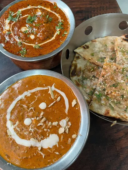 A perfect North Indian meal is all about the right combination of rich curries and fresh bread. Here you can see our Paneer Lababdar and Dhaba Chicken Curry, ready to be enjoyed with a soft Butter Naan. This is the kind of comforting meal we love to serve.