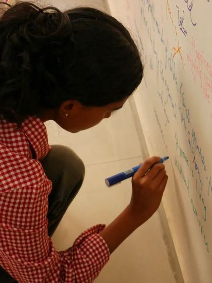 Another volunteer adds her message of hope to our wall.