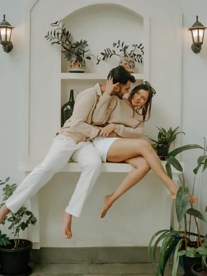 A moment of pure joy and laughter. This candid shot captures the couple in a playful embrace at their Goa villa, showcasing the fun and comfortable connection they share.