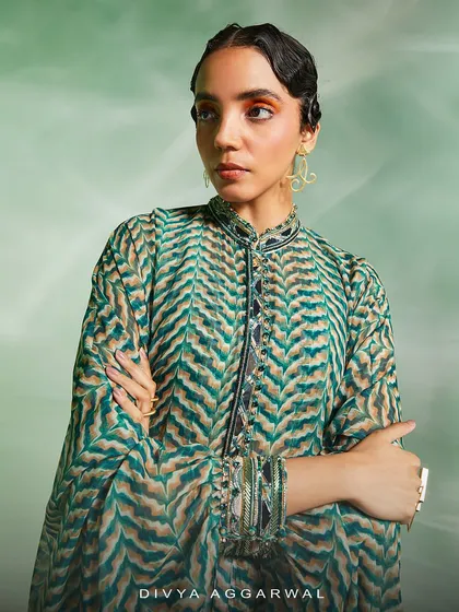 The Riley Cape Set, where a vibrant green print is enhanced with mirror work on the collar and cuffs for a look that infuses utter grace.