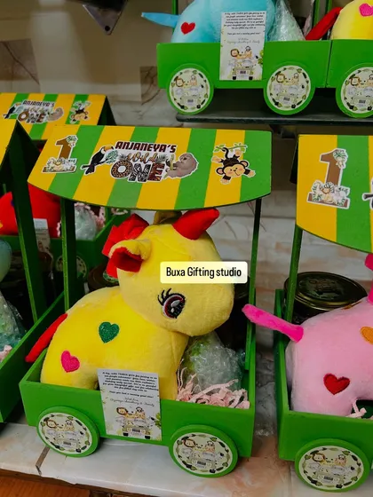 A whole family of colorful soft toys ready to go into the jungle-themed birthday carts.