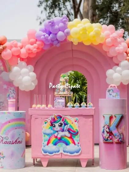 For Kaashni's unicorn party, we created a complete dreamscape in pastel pinks, purples, and yellows. The setup features a rainbow balloon arch, custom character cutouts, and themed pedestals for the cake and desserts, making it a perfect photo backdrop.