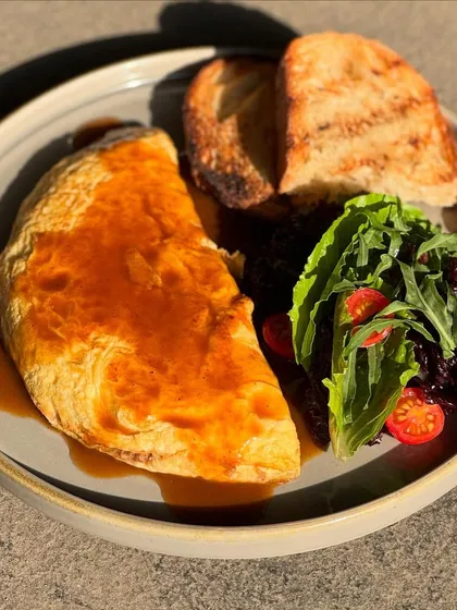 Sunlight catching our Braised Lamb Omelette. A perfect plate for a bright Sunday morning.