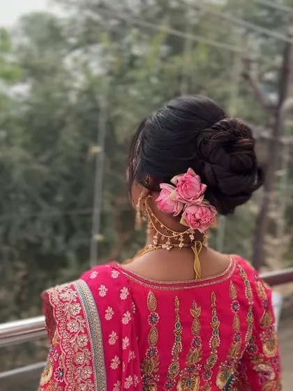 A side view of the floral messy bun, showing how fresh flowers can be tucked in to add a pop of color and romance to a traditional bridal look.
