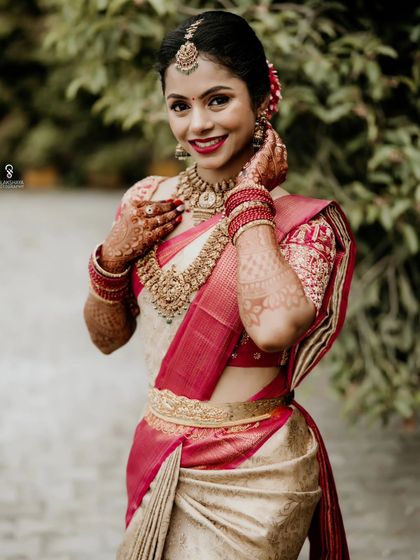 A classic bridal portrait, capturing the bride's elegance and the intricate details of her saree and jewelry.