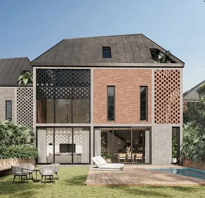 The rear facade of a townhouse in the Kolgaon Masterplan shows our modular patchwork of materials, including local brick and perforated screens. The design connects the home to a private garden and pool, demonstrating the link between individual and community landscapes.
