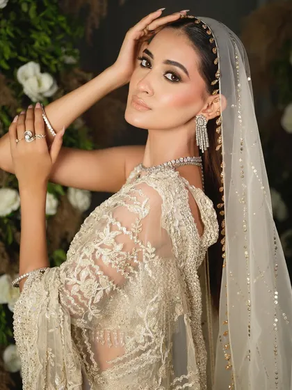 A beautiful portrait that highlights the bride's features and the sparkling diamond earrings. The styling is clean and sophisticated.